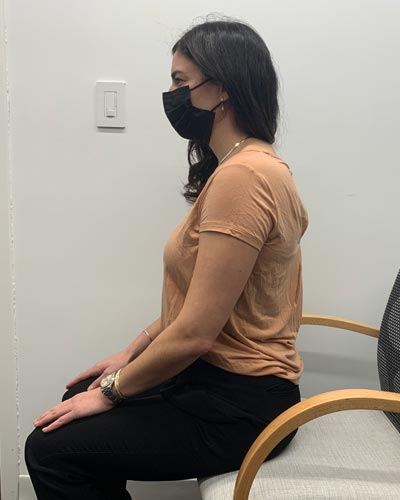 photo of woman demonstrating neck retraction stretch