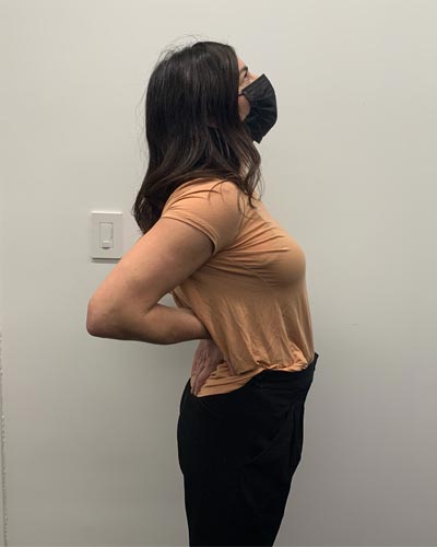 photo of woman doing standing lumbar extension stretch