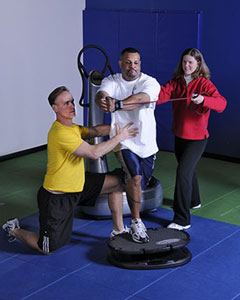 Photo of Barry Heyden and Polly de Mille demonstrating the Power Plate 