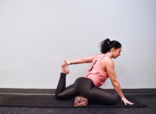 photo of cara demonstrating Pigeon with quad stretch 1 of 2
