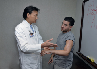 Photo of Steve K. Lee, MD examining a patient