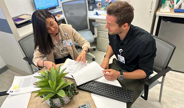two researchers looking at paperwork together