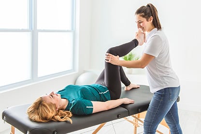 Photo of female physical therapist working with a female patient