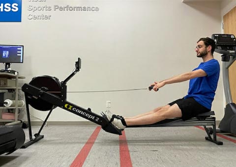 photo of aaron karp pulling back with arms