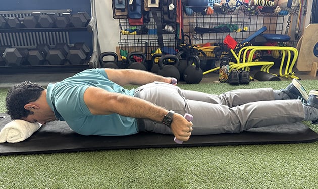 Prone exercise end position with arms raised upward
