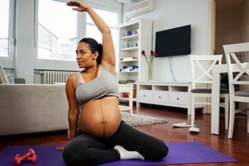photo of pregnant woman stretching
