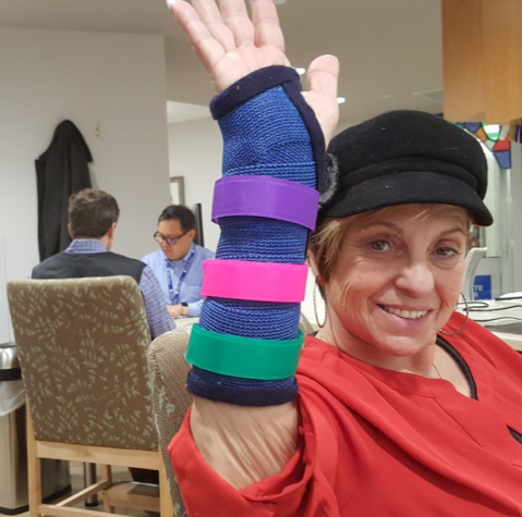 Senior woman shows off a brightly covered wrist brace