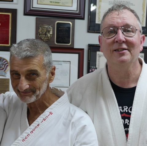 Two men posing in white martial arts robes