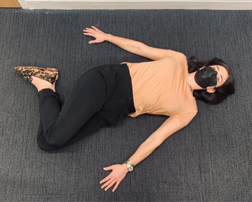 photo of woman doing a trunk rotation stretch