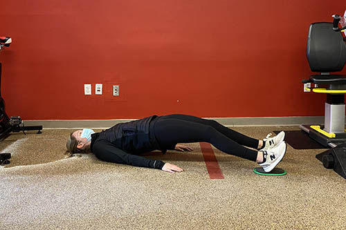 supine hamstring curl bridge position