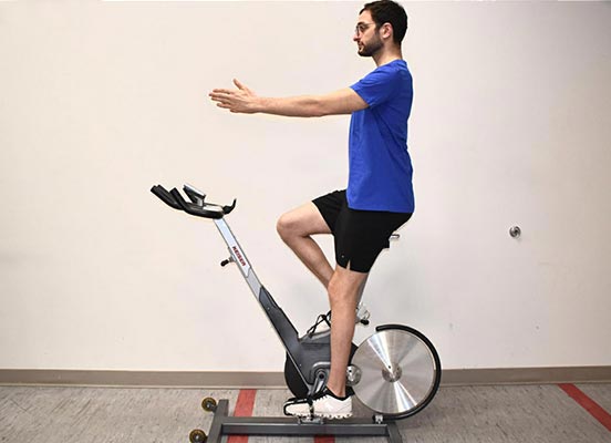 man on exercise bike demonstrating handlebar height