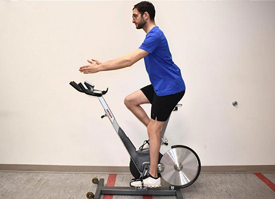 man on exercise bike demonstrating handlebar height