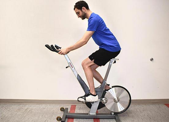 man on exercise bike demonstrating handlebar height