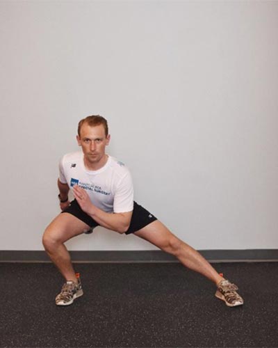man demonstrating lateral lunges