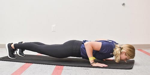 woman demonstrating push up exercise
