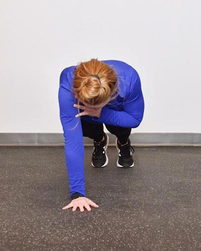 woman performing shoulder tap exercise