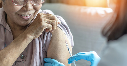 A woman receiving a vaccination shot.