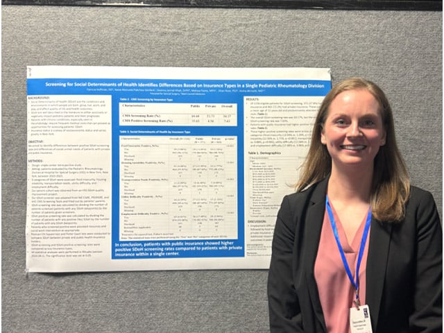 Fellows presenting research poster at a medical conference