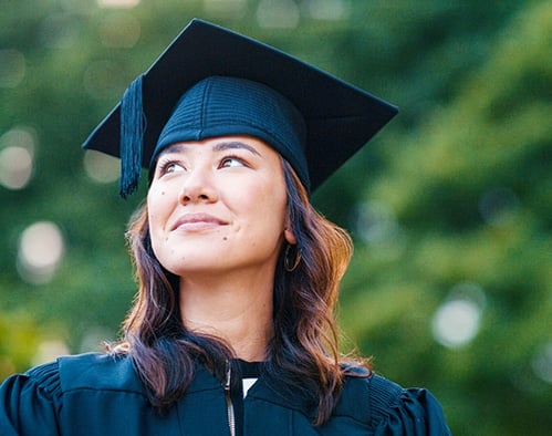 image of woman in cap and gown looking upwards