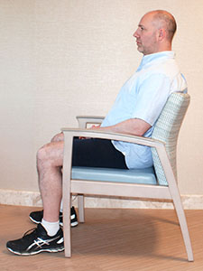 Photo of a man sitting in a chair