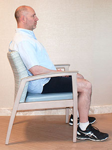 Photo of a man sitting in a chair
