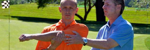 A golfer doing an arm stretch