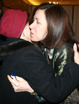 Photo of Roberta Horton greeting an attendee