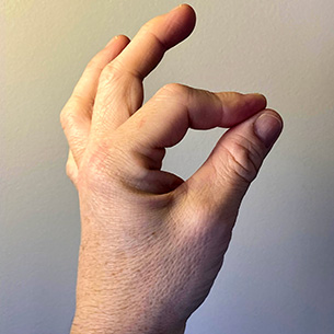 A hand with the thumb and forefinger touching.