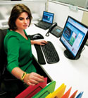 Image of a woman sitting at a computer