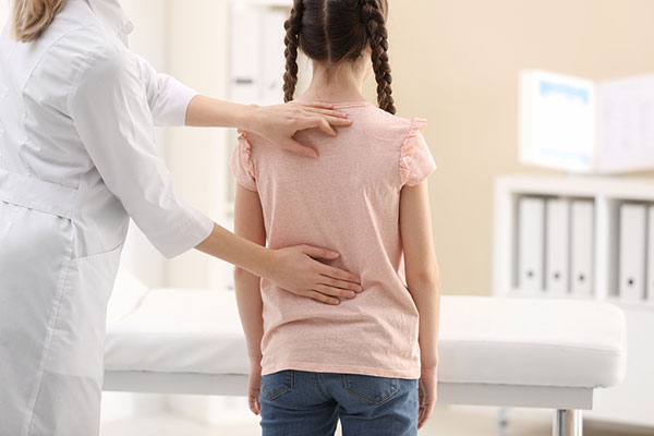health professional examining girl's back
