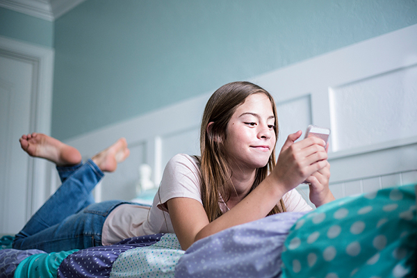 photo of girl in bed texting