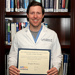 Dr. Doug Wetmore holds his award certificate