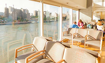 seating area and view of Roosevelt Island and East River from the 4th floor atrium.