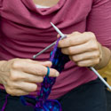 Close up photo of a woman knitting
