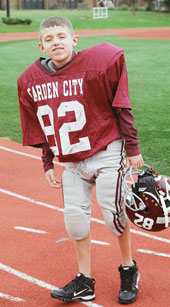 Bobby posing in his football uniform.