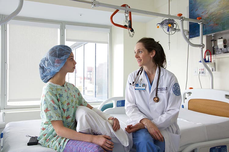 Dr. Kate DelPizzo talks with a pediatric patient
