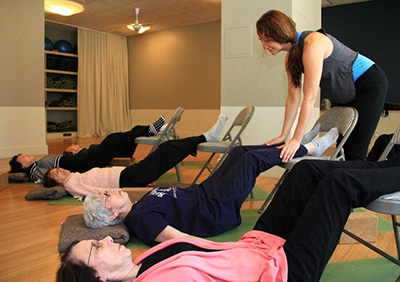 Photo of older adults exercising in a class.