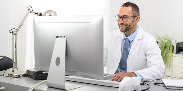 A physician in his office on the computer