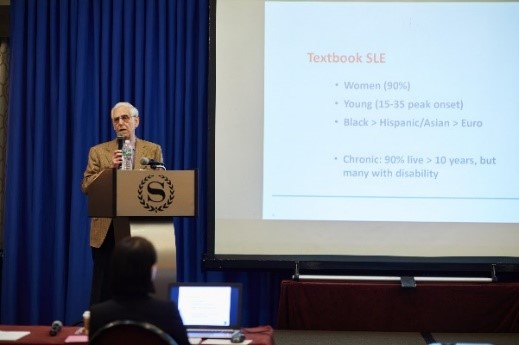 Photo of Dr. Michael Lockshin presenting on SLE.