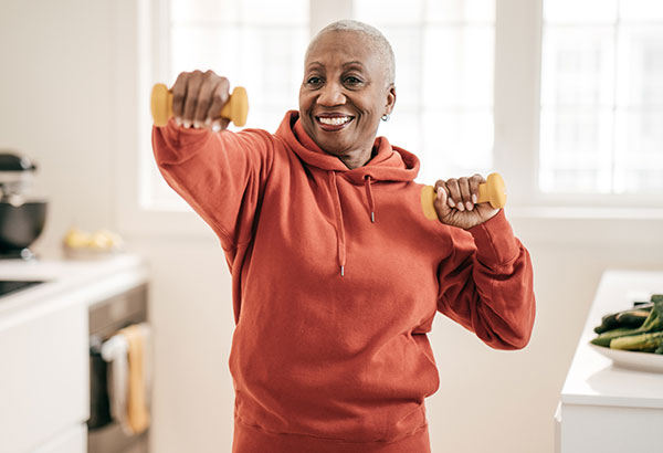 Older woman doing aerobics from home