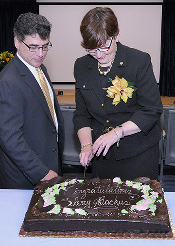 Image - Sherry Backus cutting cake at ceremony