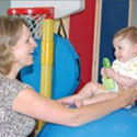 Image of a woman playing with an infant