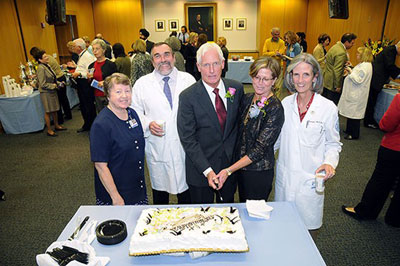 Image - Edward Craig, MD, cuts cake at ceremony