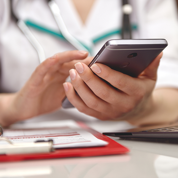 Icon image of a doctor using a smartphone.