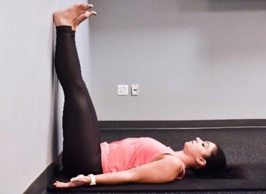 photo of cara demonstrating Legs-up-the-wall stretch