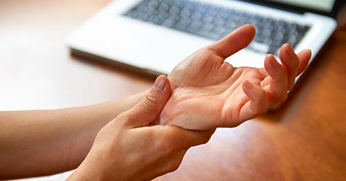 A person massaging their wrist.