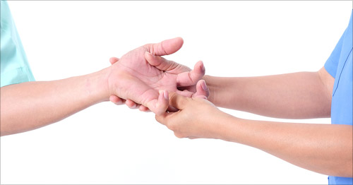 A doctor examining a patient's hand.