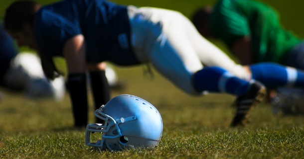 Football players doing pushups.