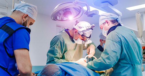 Spine surgeons in the operating room doing lumbar laminectomy surgery.