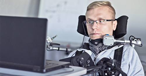 A man with ALS with assistive devices.